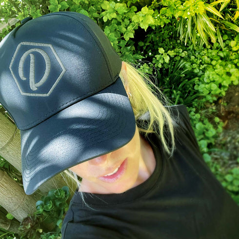 Black 5 Panel Cap with White Thread D&H Icon, modelled by Ash